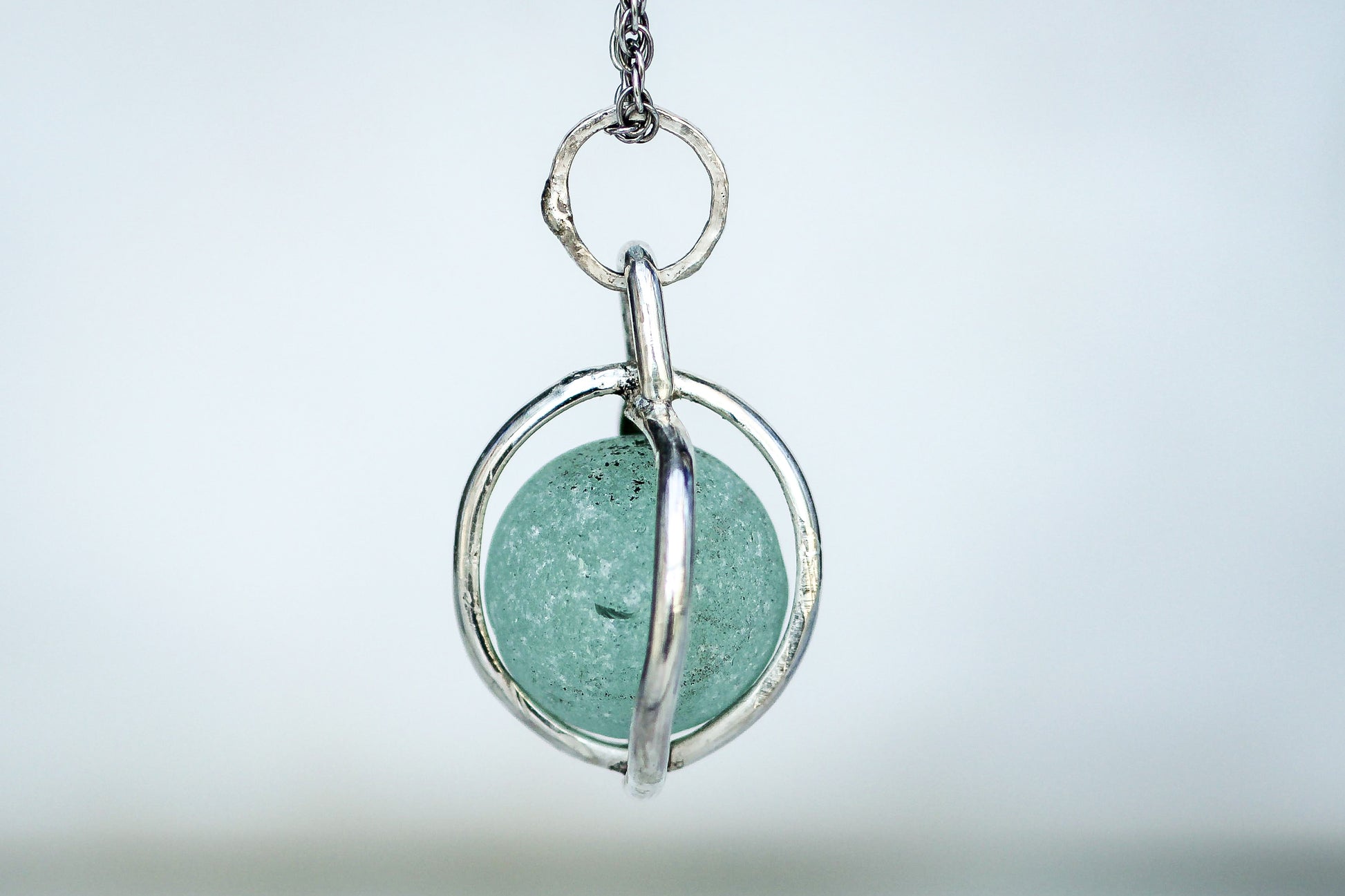 Ocean treasure necklace featuring authentic Victorian Codd marble in silver cage