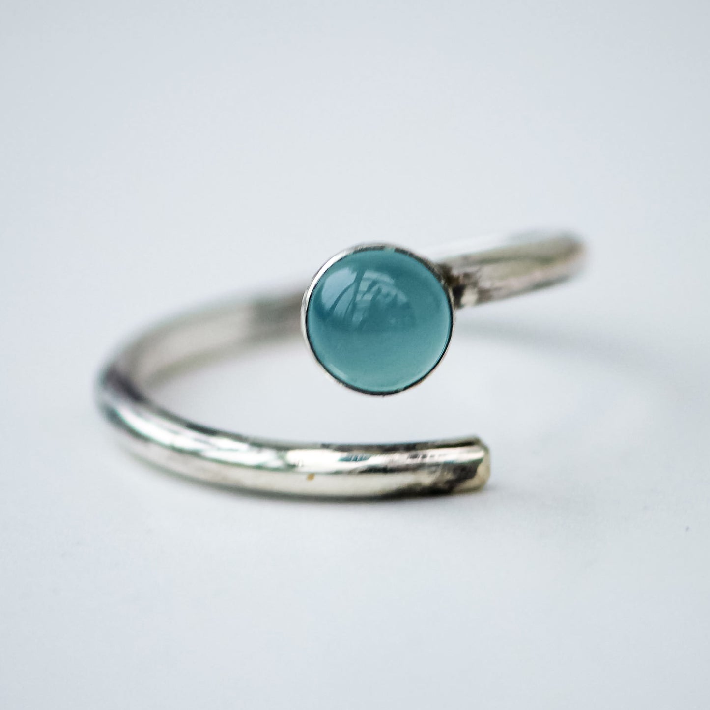 One of a kind handmade chalcedony ring in sterling silver. Adjustable silver band, soft ocean-blue gemstone. Handcrafted by Louella Jewellery.