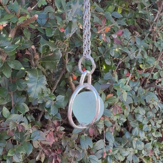 Video of turquoise Codd sea glass marble spinning freely inside sterling silver cage necklace
