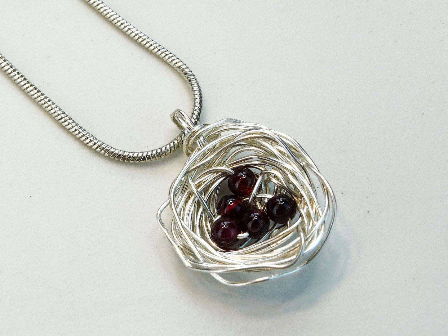 Birds nest pendant, necklace with red gemstone eggs | Necklace | Louella Jewellery