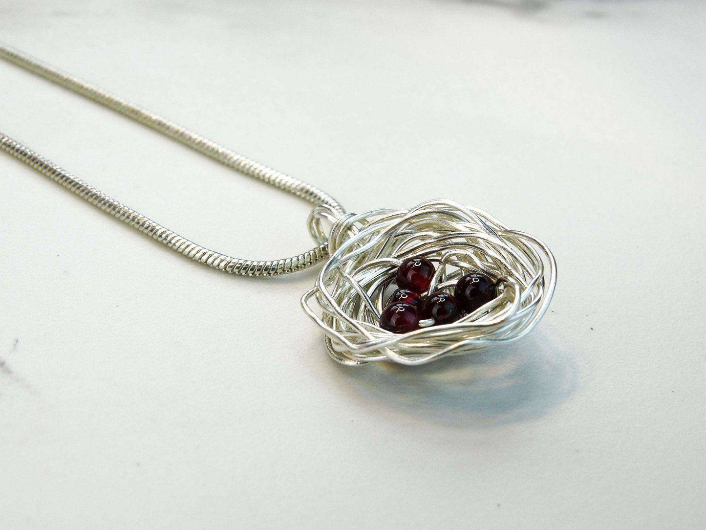 Birds nest pendant, necklace with red gemstone eggs | Necklace | Louella Jewellery